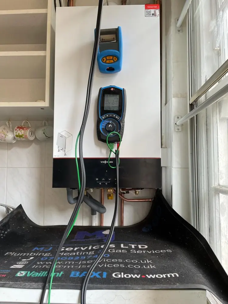 Flue gas analyser connected during a boiler service