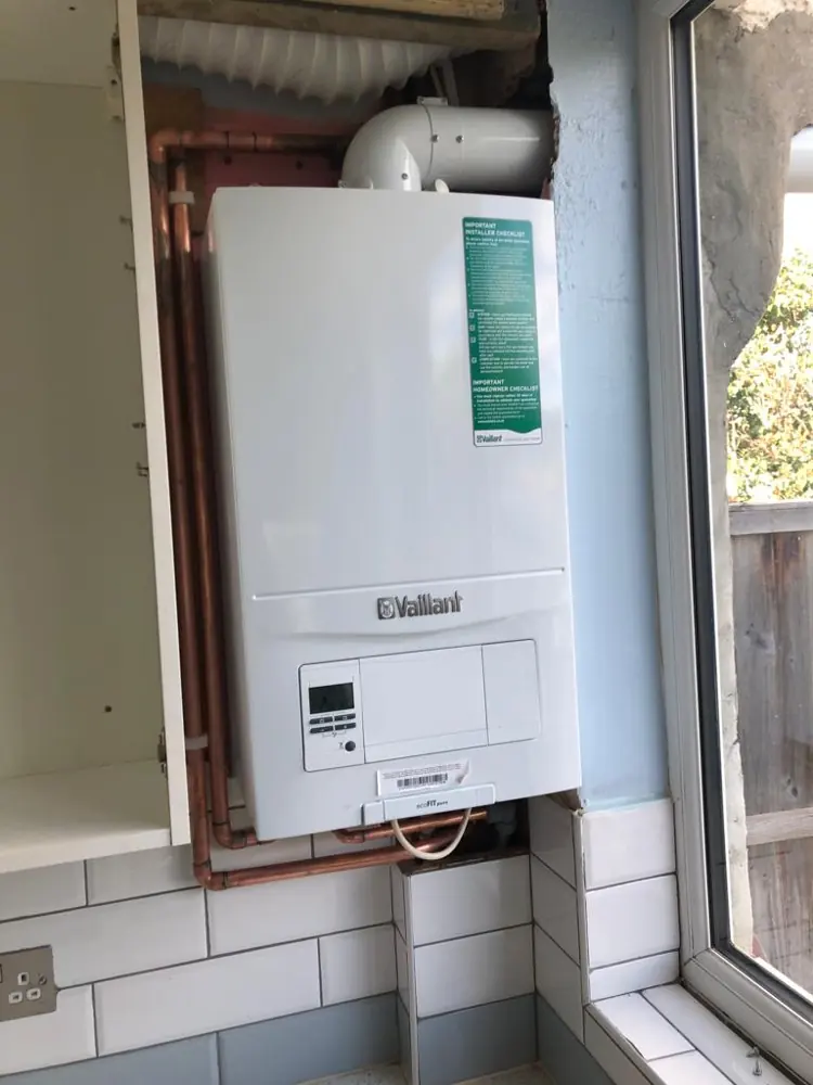 New Vaillant combi boiler fitted in a kitchen cupboard