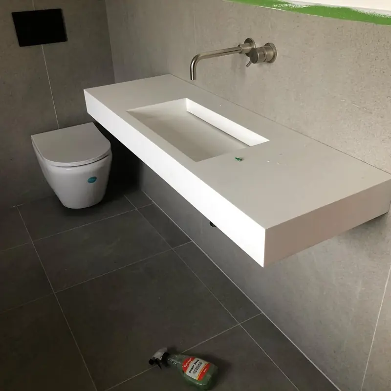 Floating stone basin with wall mounted tap