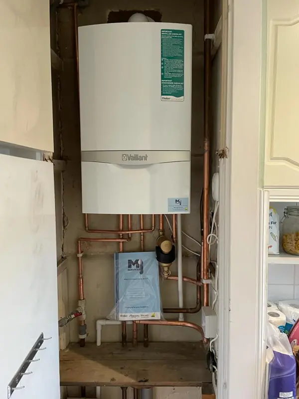 New Vaillant boiler with neat pipework in a cupboard