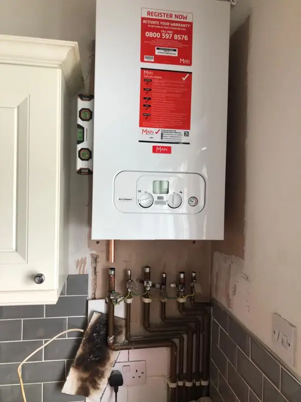 Combi boiler with warning labels checked during an inspection