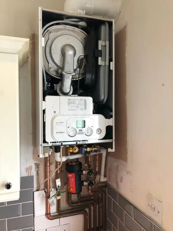 Boiler opened up for a repair with parts exposed