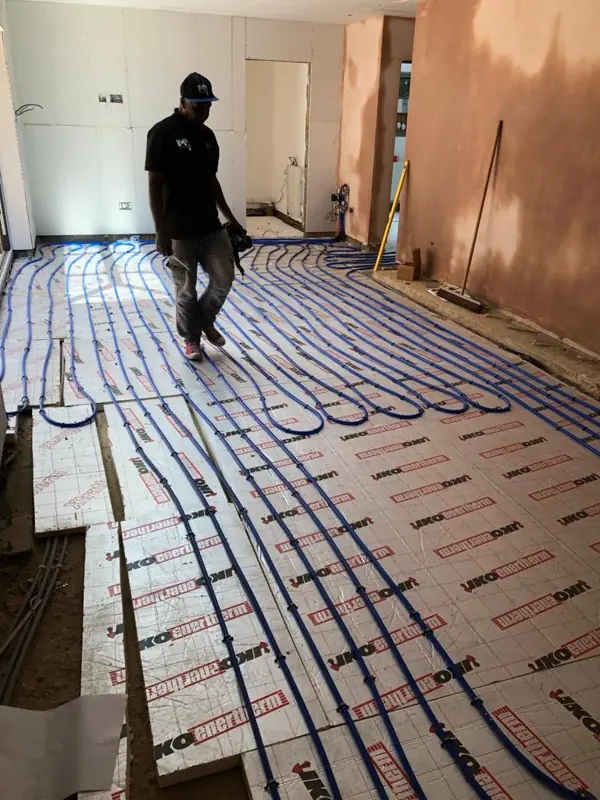 Underfloor heating pipes laid across a kitchen extension