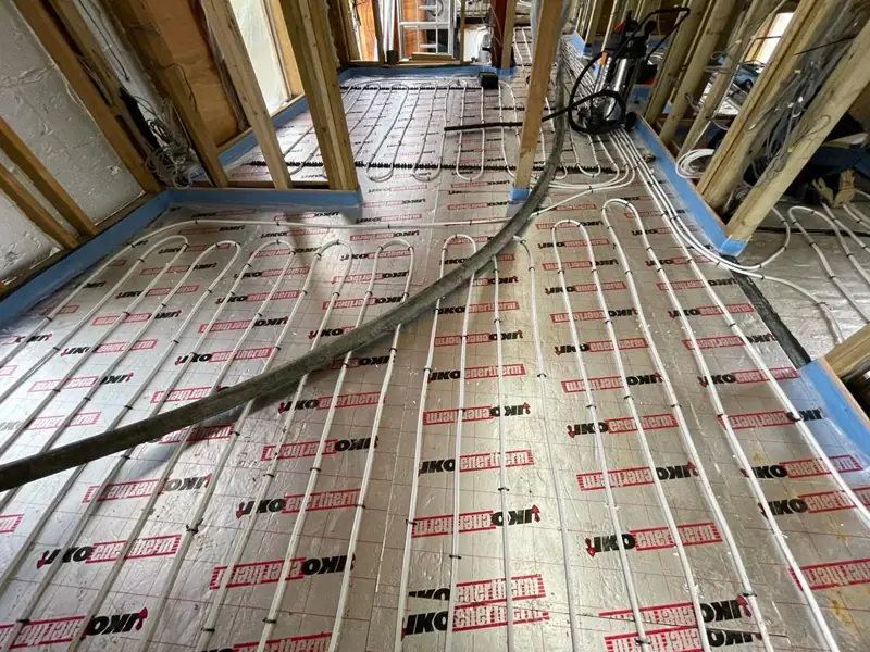 Underfloor heating pipes in a timber framed garden room