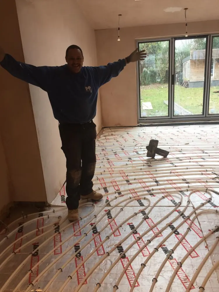 Selvin standing on underfloor heating pipes laid across an extension