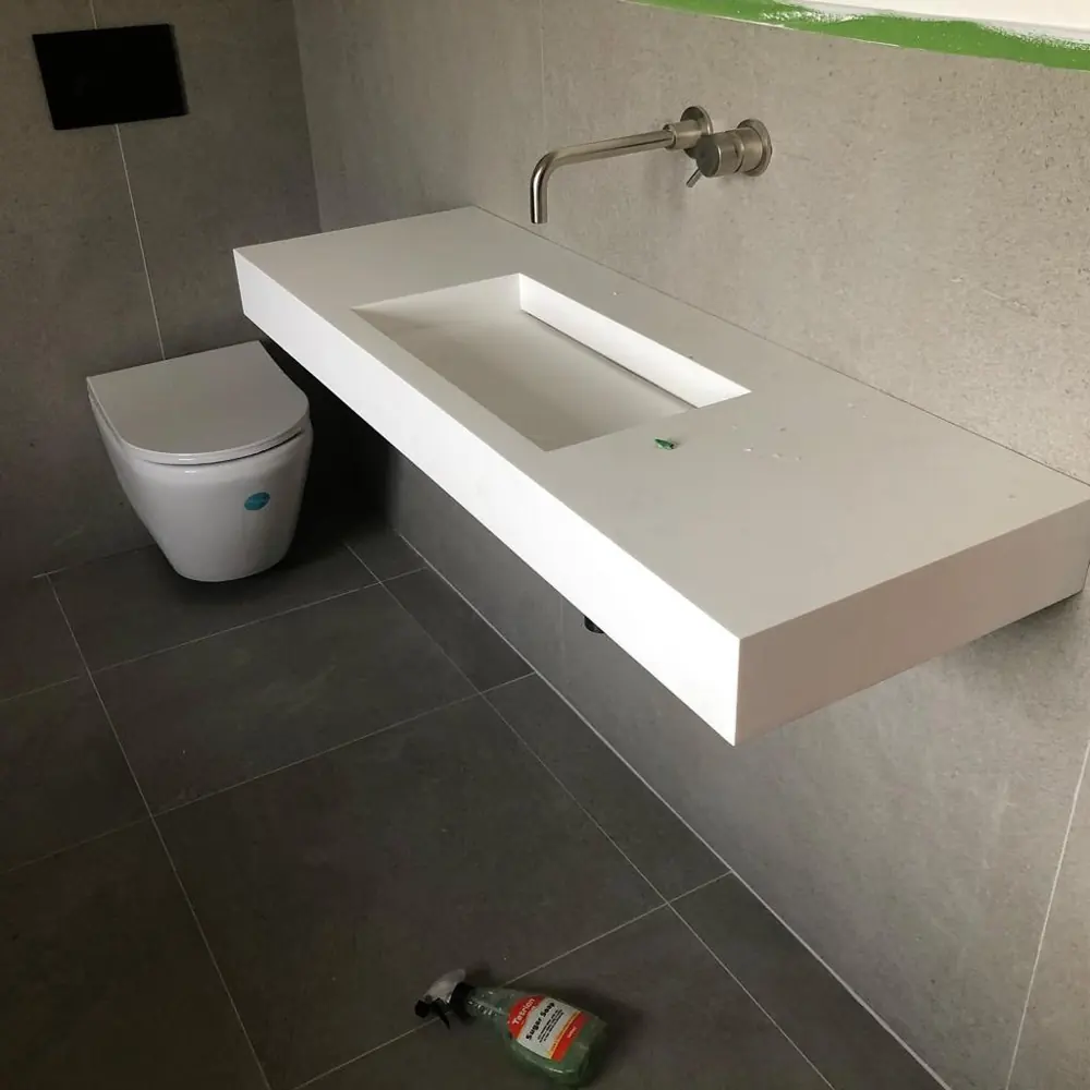 Floating stone basin with wall mounted tap