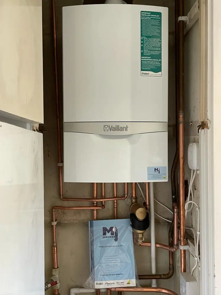 Vaillant boiler with copper pipework in a utility cupboard