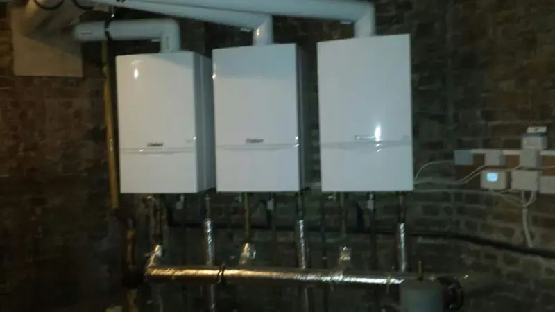 Three wall hung boilers in a commercial plant room