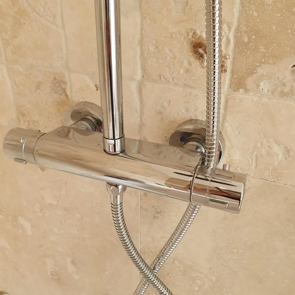 Chrome thermostatic bar shower valve on travertine tiles