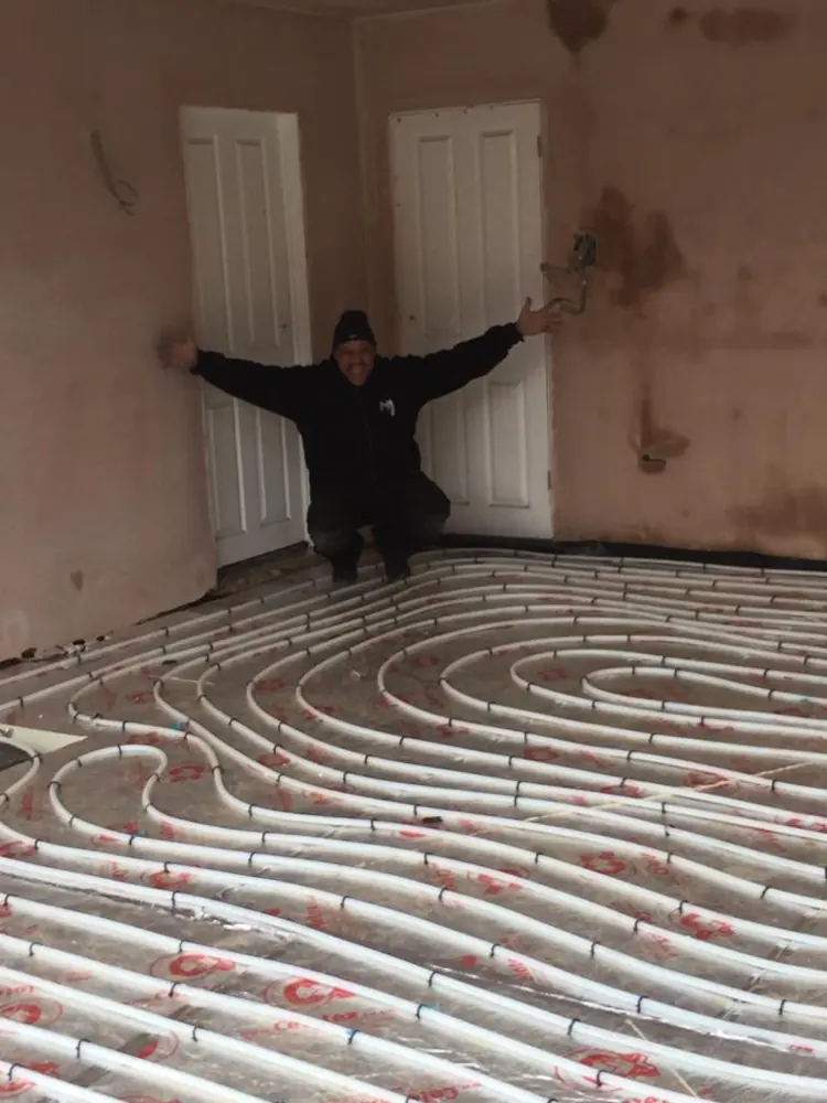 Spiral underfloor heating pipe layout across a large room