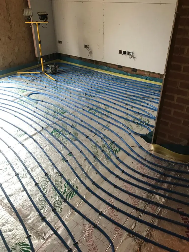Underfloor heating pipes running across a kitchen extension